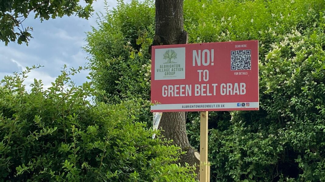 A red placard on a wooden pole with the words 