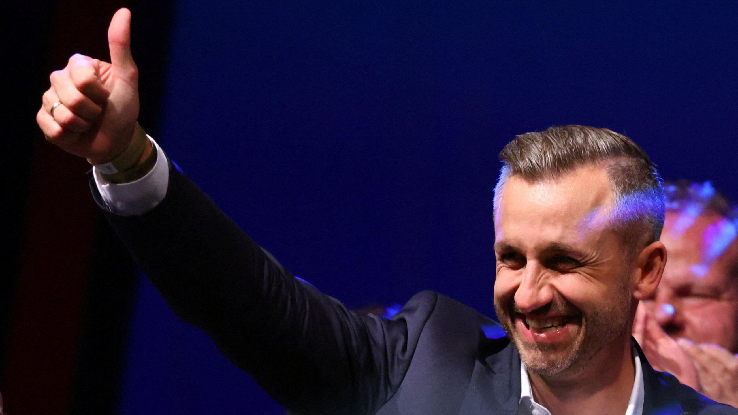 Ulrich Siegmund, leader of the AfD in the state, raises a thumbs up at the election party.