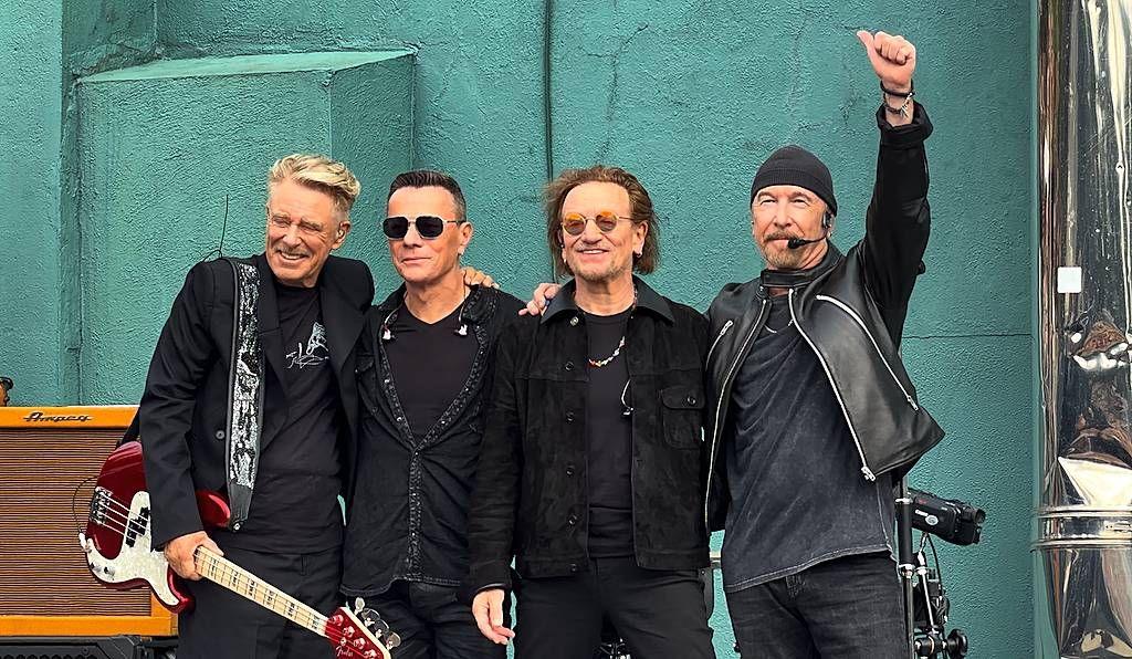 U2 on stage at their former school