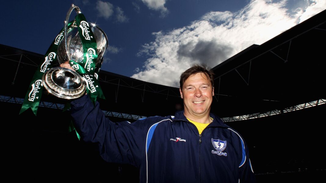 Ian Chandler holds aloft the FA Vase trophy