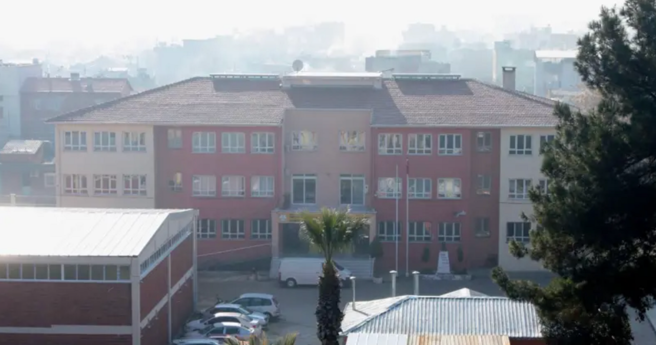 A photo of the school where the attack took place, taken in 2022 - it's a three story building that looks fairly modern but unremarkable - it has a mix of cream and red colouring and is seen from a middistance
