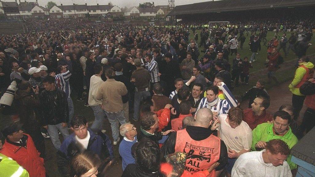 Brighton fans run onto the pitch after the final match at the Goldstone Ground in April 1997