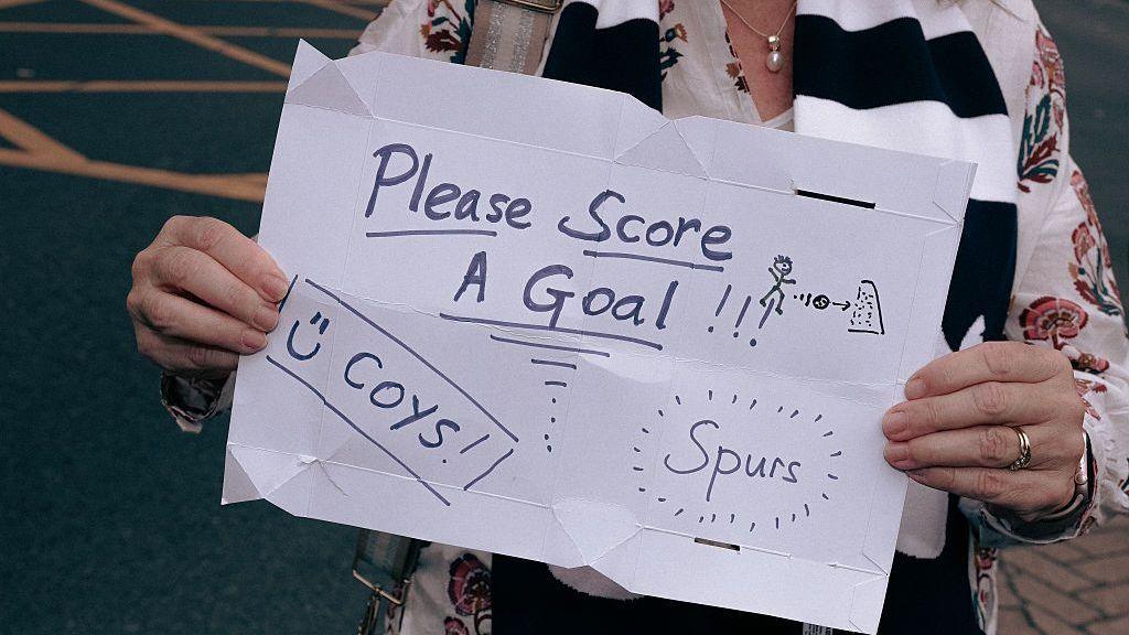 Spurs fan sign asking Tottenham to score a goal