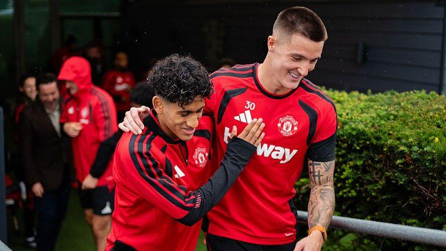 JJ Gabriel (left) has a joke with Manchester United team-mate Benjamin Sesko