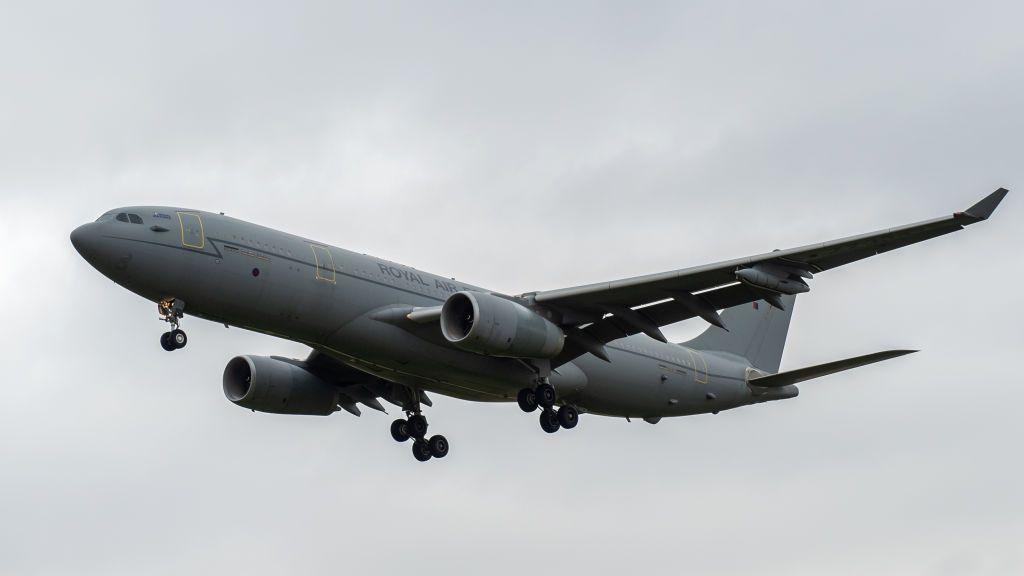 A grey RAF Voyager seen flying through cloudy skies
