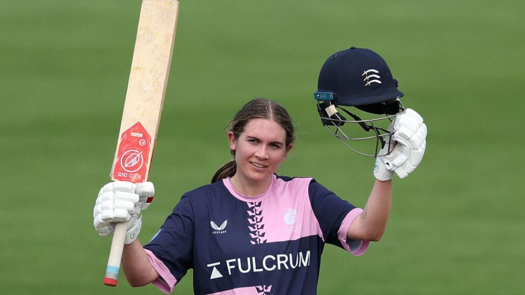 Saskia Horley raises her bat after a century for Middlesex against Glamorgan