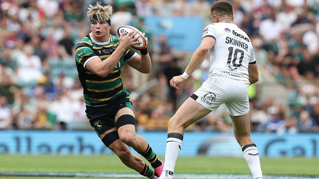 Henry Pollock runs past Harvey Skinner