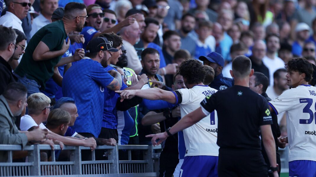 Cardiff fans get into an argument with Portsmouth fans and officials