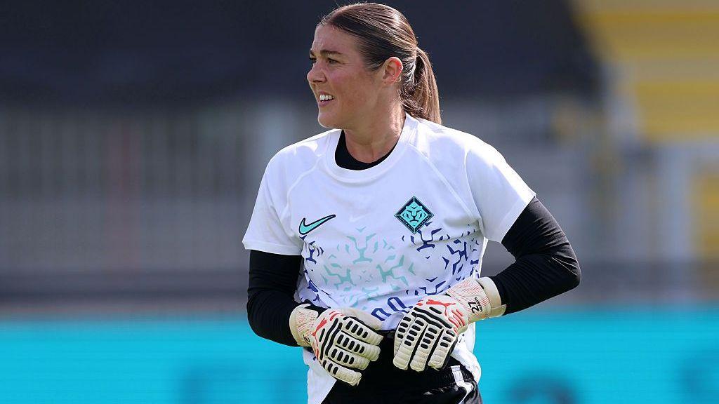 Mary Earps, wearing a white goalkeeper top with black long-sleeved undershirt and black shorts, during a London City Lionesses training session
