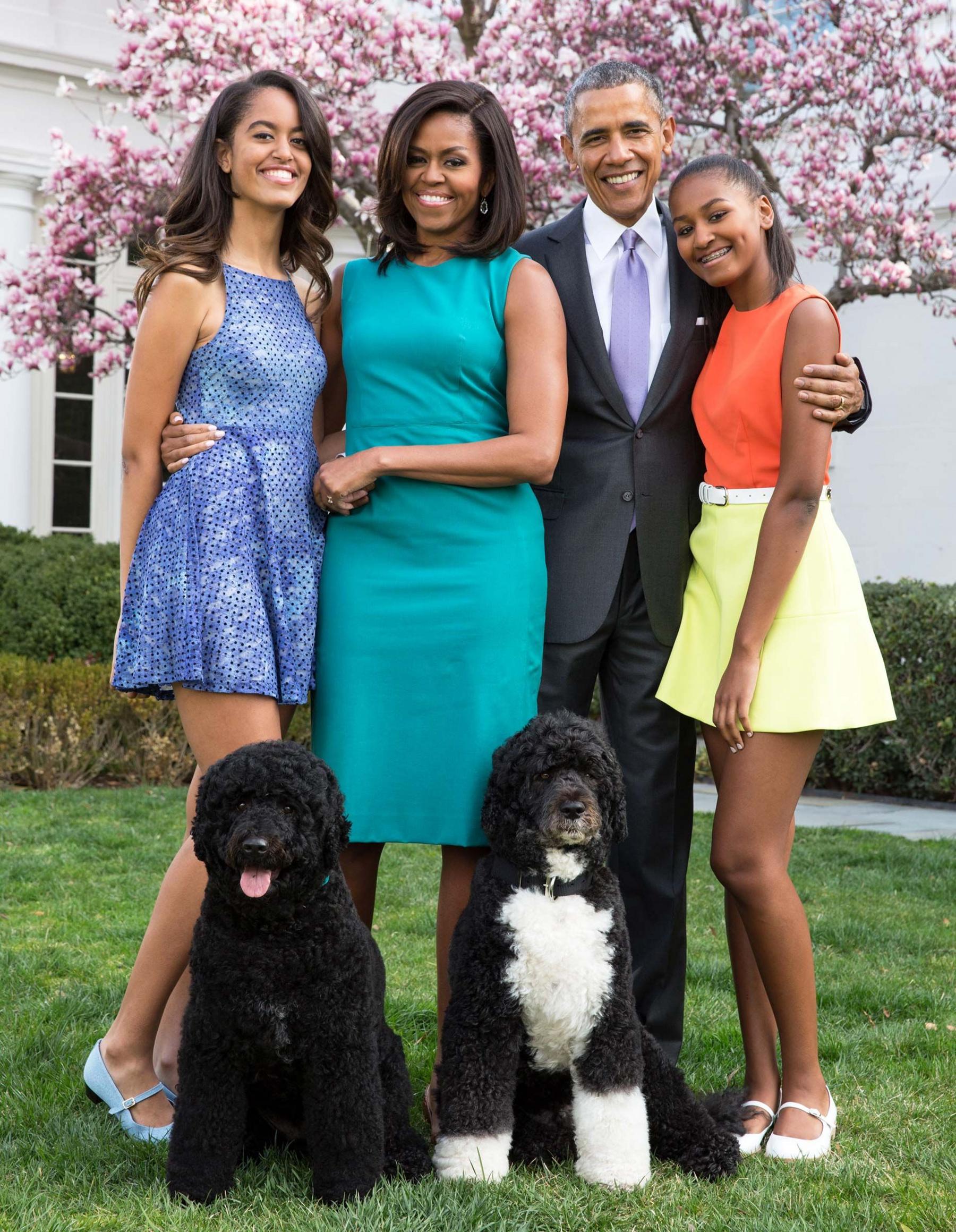 U.S. President Barack Obama, First Lady Michelle Obama, and daughters Malia (L) and Sasha (R) pose for a family portrait with their pets Bo and Sunny in the Rose Garden of the White House on Easter Sunday, April 5, 2015 in Washington, DC.