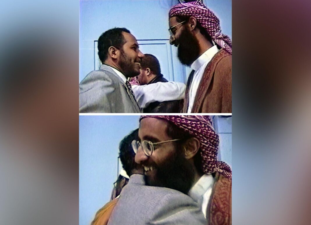 New videos of man at centre of 9/11 lawsuit reveal links to extremists and Saudi state A composite of two stills from video footage showing two men, one in a suit and the other in Arabic dress. The top image shows the men about to embrace. The bottom shows the moment they do.