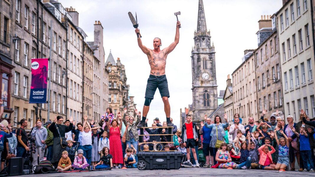 England’s mayors to be given power to introduce tourist tax A bare-chested male street performer in front of a crowd on Edinburgh's Royal Mile.