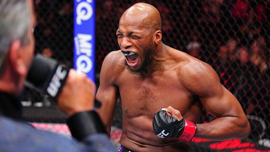 Michael Page shouts and pumps his fist in the UFC octagon before a fight