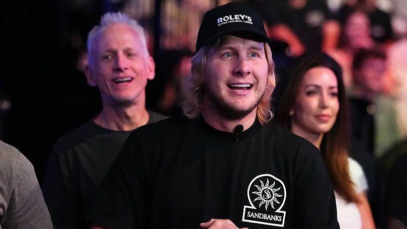 Paddy Pimblett smiles and is wearing a black t-shirt