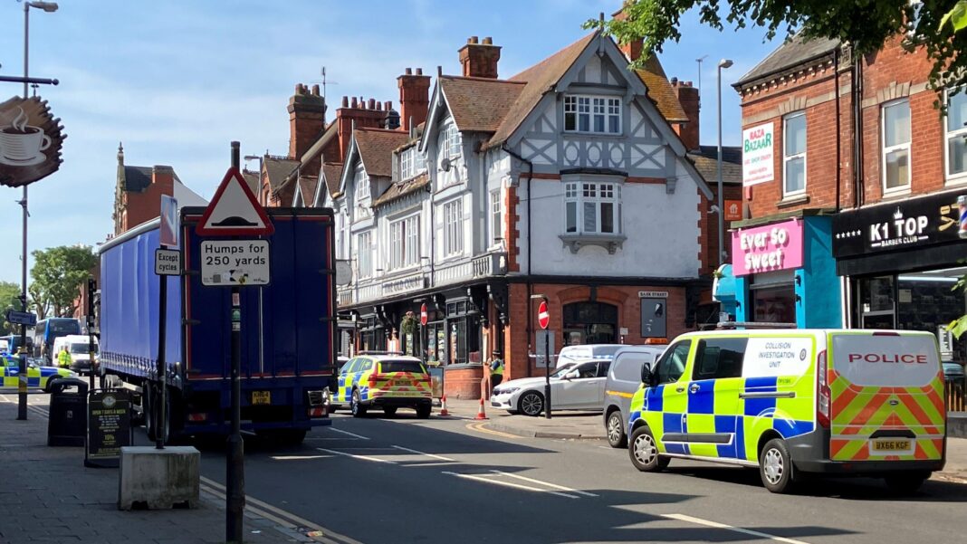 ‘We feel abandoned by police’: A community’s despair after months of crime Several police cars are parked along High Street, Kings Heath. A police van is to the right, and a police car is just in front of it. There are shops and businesses also on the right. A blue lorry is parked on the left-hand side of the busy road.