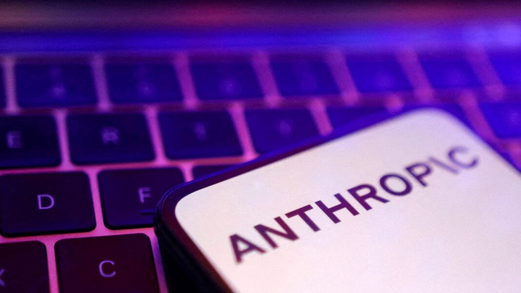 Dramatic insider warnings over AI fall flat with some in Silicon Valley A smartphone display showing the Anthropic logo in black letters on an all-white background, laid on a laptop keyboard lit in pink and purple
