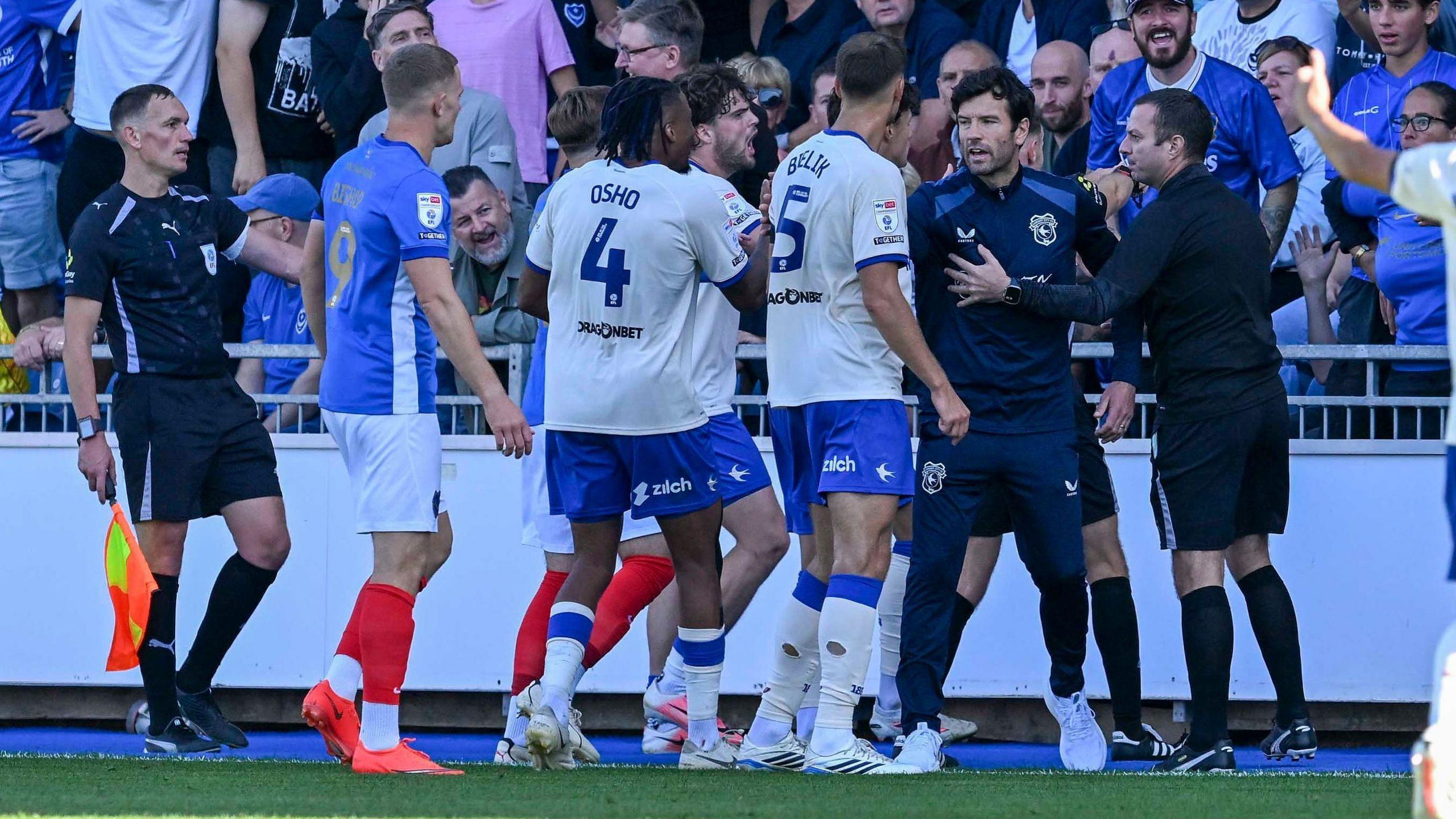 Cardiff players and coaches and Portsmouth fans get into an altercation.