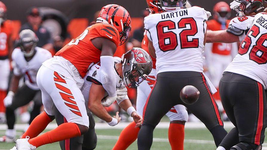 Cincinnati Bengals defensive end Boye Mafe tackles Tampa Bay Buccaneers quarterback Baker Mayfield to force a fumble