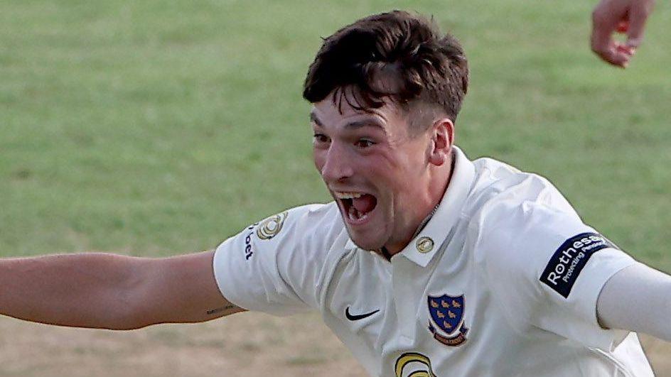 Sussex bowler Henry Crocombe celebrates with his mouth open