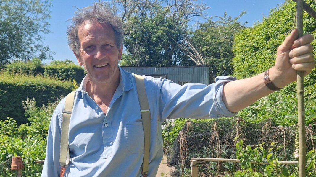 Monty Don to leave Gardeners’ World after more than 20 years Monty Don in a blue shirt and braces holding a garden cane with one hand, in a generic promotional photo from Gardeners' World
