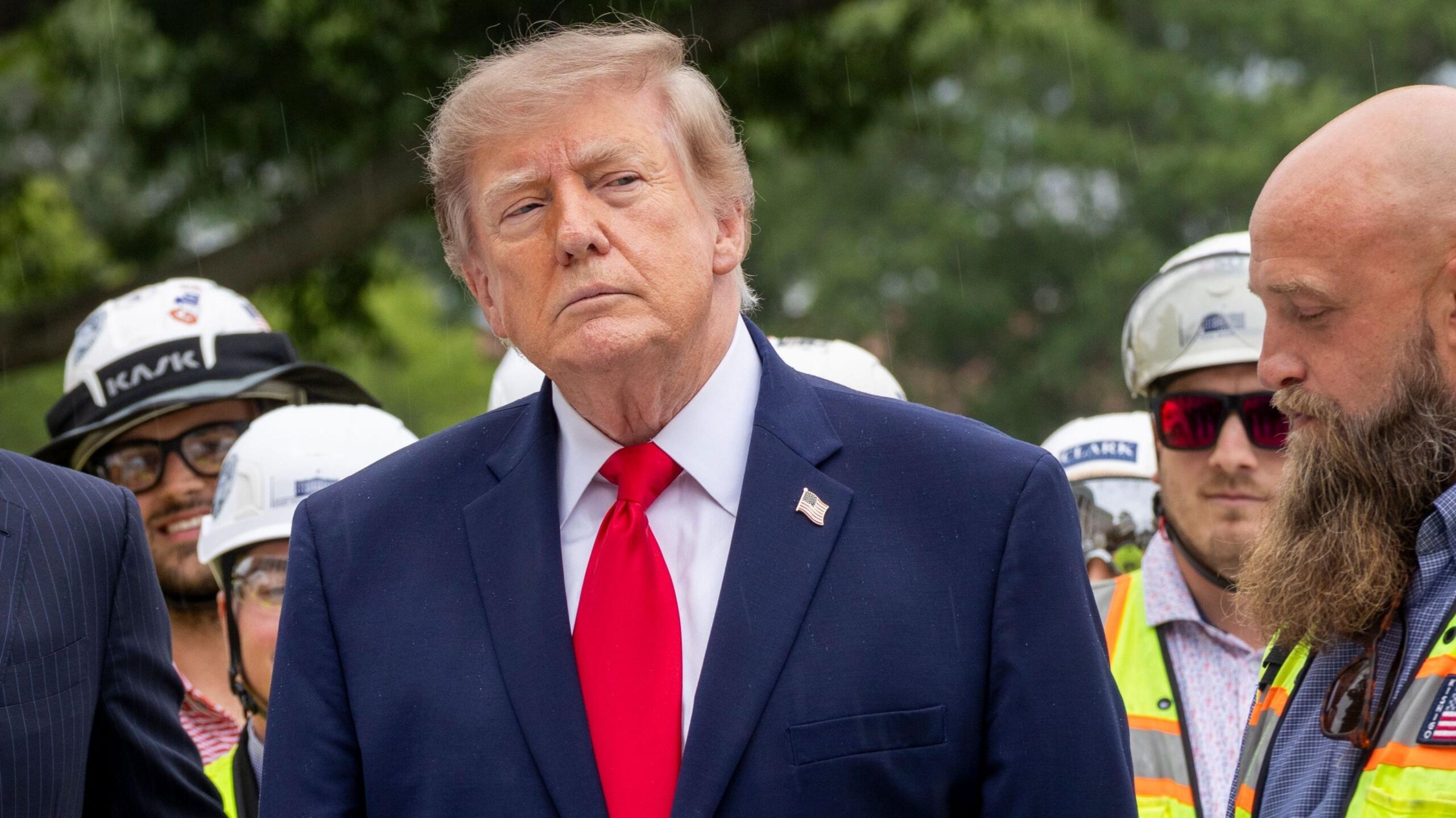 President Trump at the centre of the frame wearing a navy suit