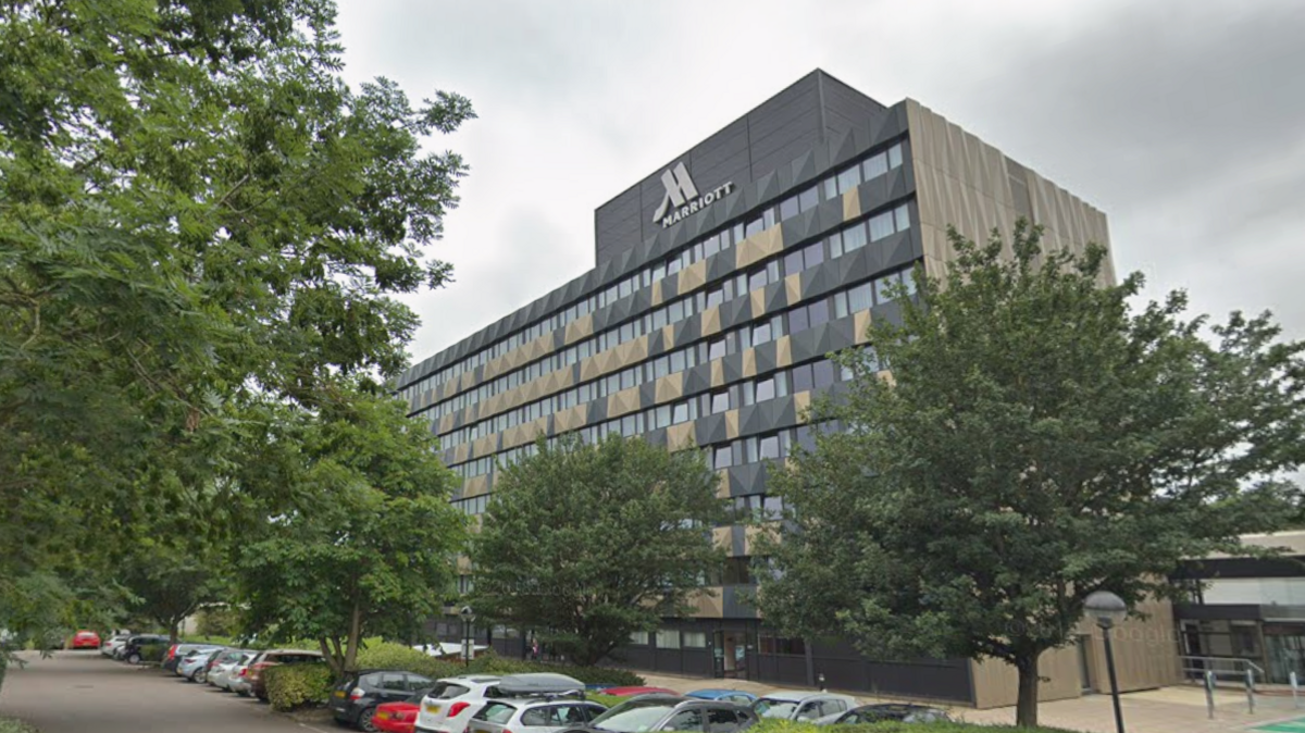 Google Street View of the Marriott Hotel in Cosham - a modern eight-storey block with the M logo on the roof. The surface car park in the foreground is full of cars and dotted with trees.