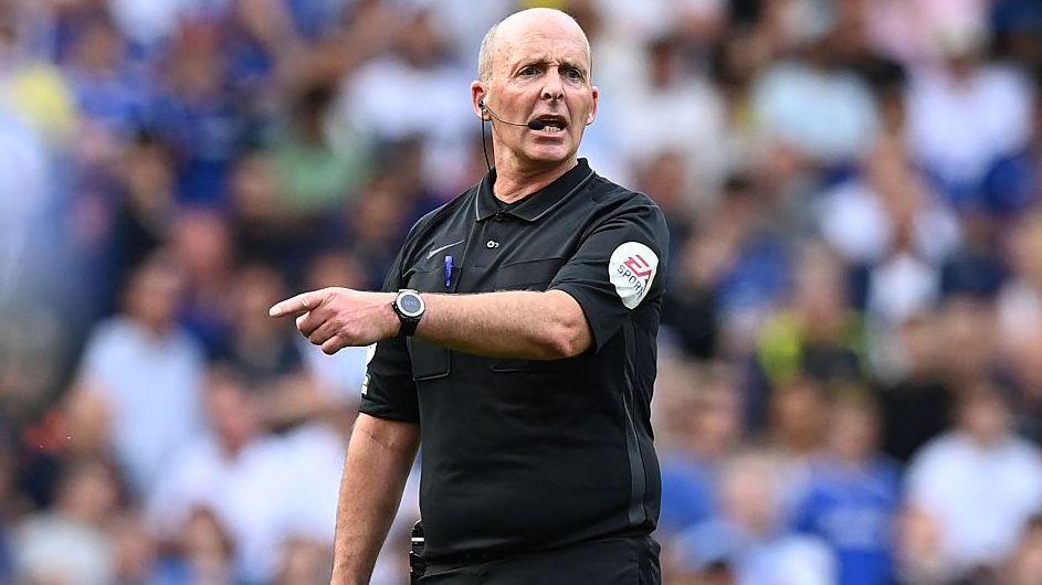 English referee Mike Dean gestures during the Premier League match between Chelsea and Watford