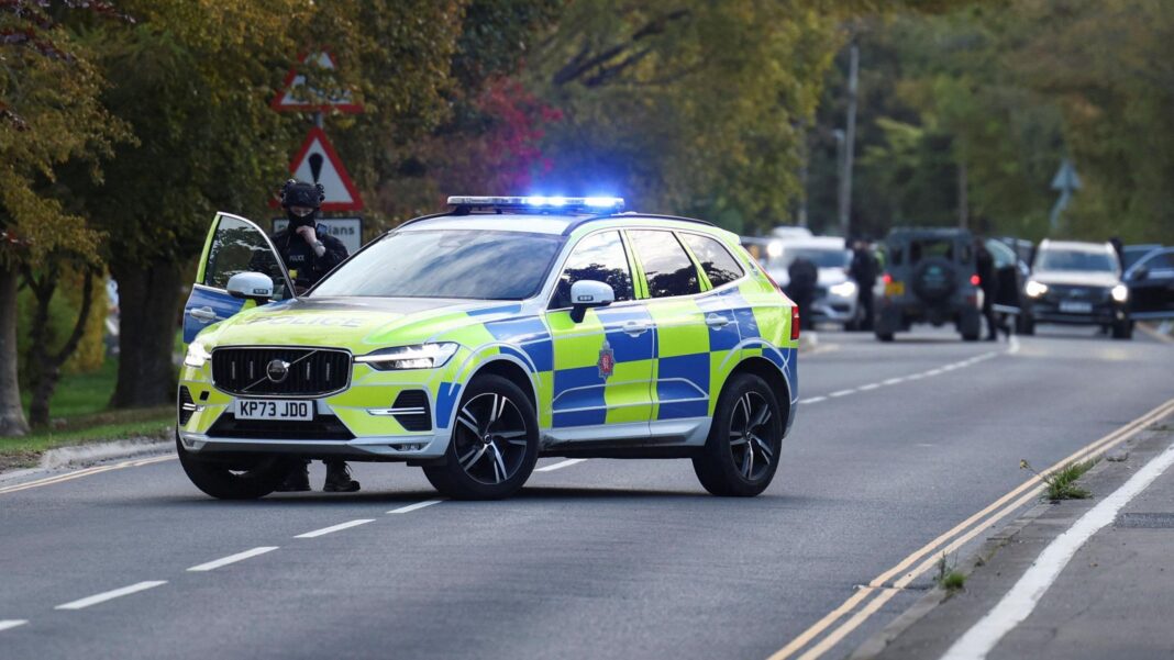 Men arrested and houses evacuated in major incident near RAF Fairford A police car is pictured on a road