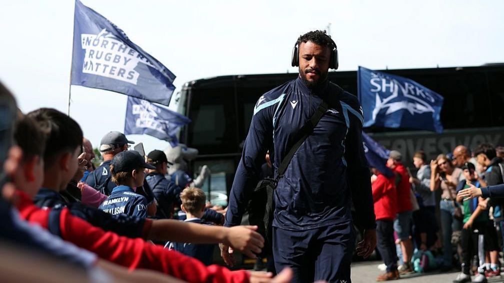 Courtney Lawes walks past fans after getting off a coach