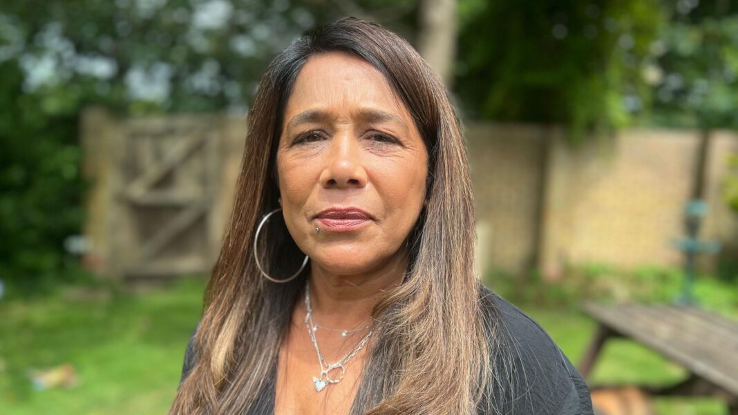 ‘Poison seller’ who sold my daughter deadly drugs should rot in hell Louise Nunn has long medium brown hair and wears a black top, silver hoop earrings and silver necklace. She is standing in a garden looking directly at the camera.