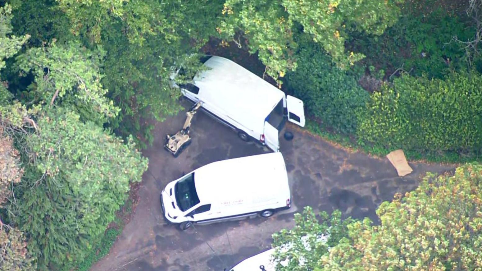 Aerial footage of robot and white vans near RAF Fairford