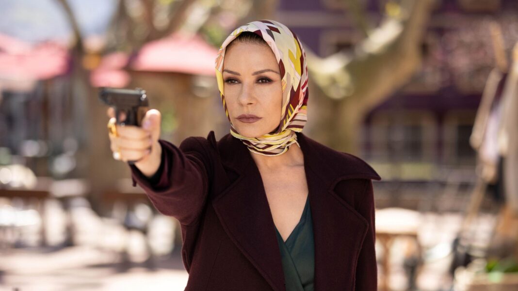 Catherine Zeta-Jones bases new role on funny Welsh people she knows Catherine Zeta-Jones holding a gun up, wearing a scarf around her head and a maroon jacket in the Kill Jackie series.