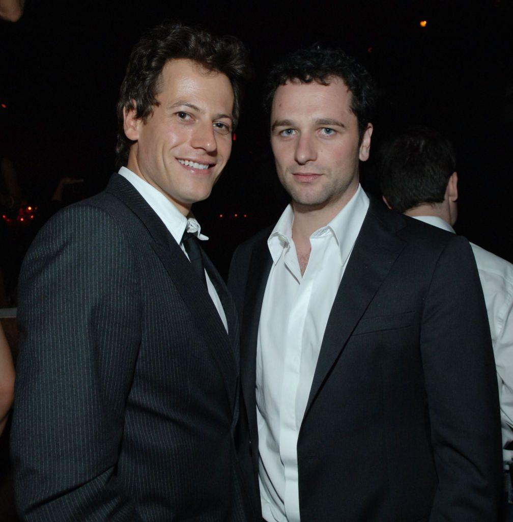Ioan Gruffudd and Matthew Rhys in dark suits and white shirts