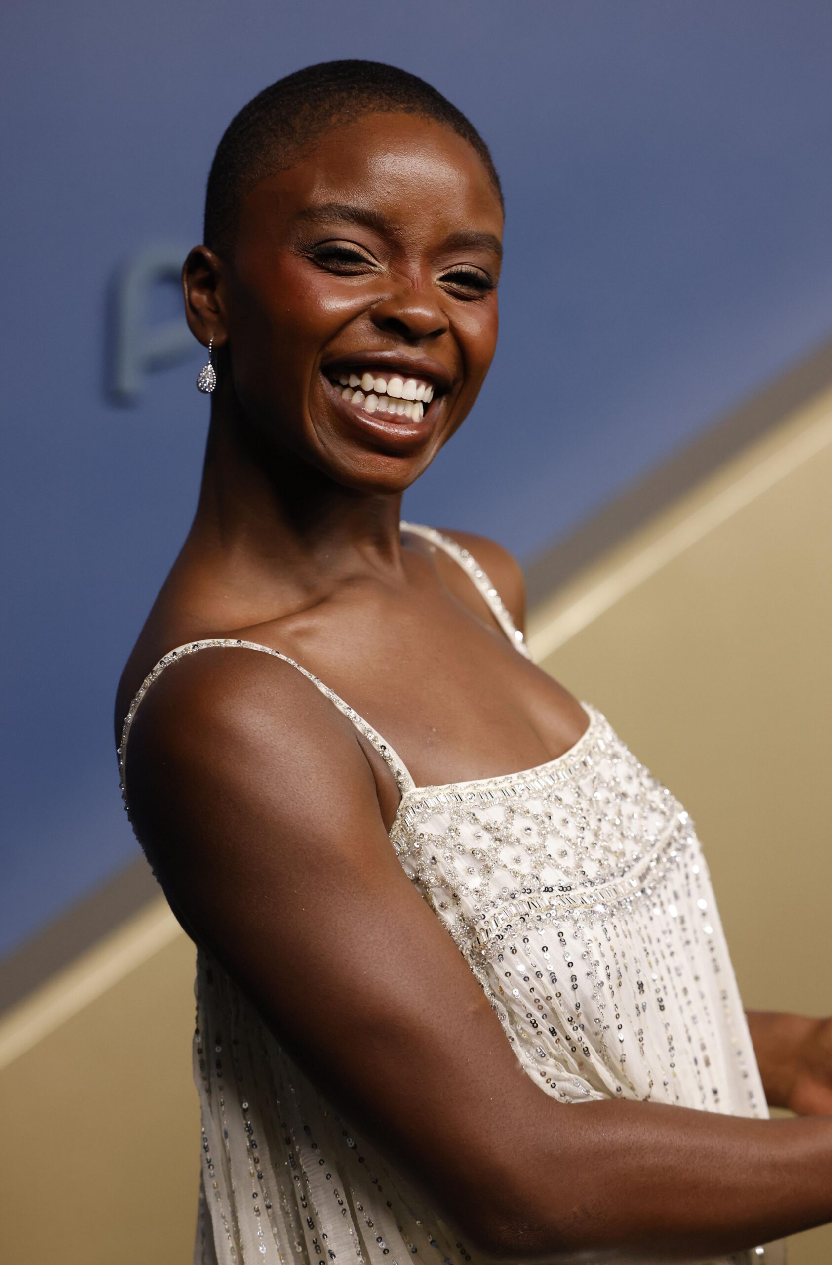 Joy Sunday smiling in a white dress