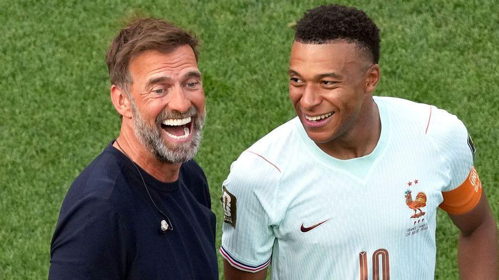 Kylian Mbappe of France and Jurgen Klopp are seen after the World Cup quarter-final match between France and Morocco