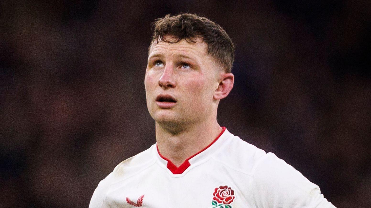 Fraser Dingwall in a white England rugby jersey during a match.