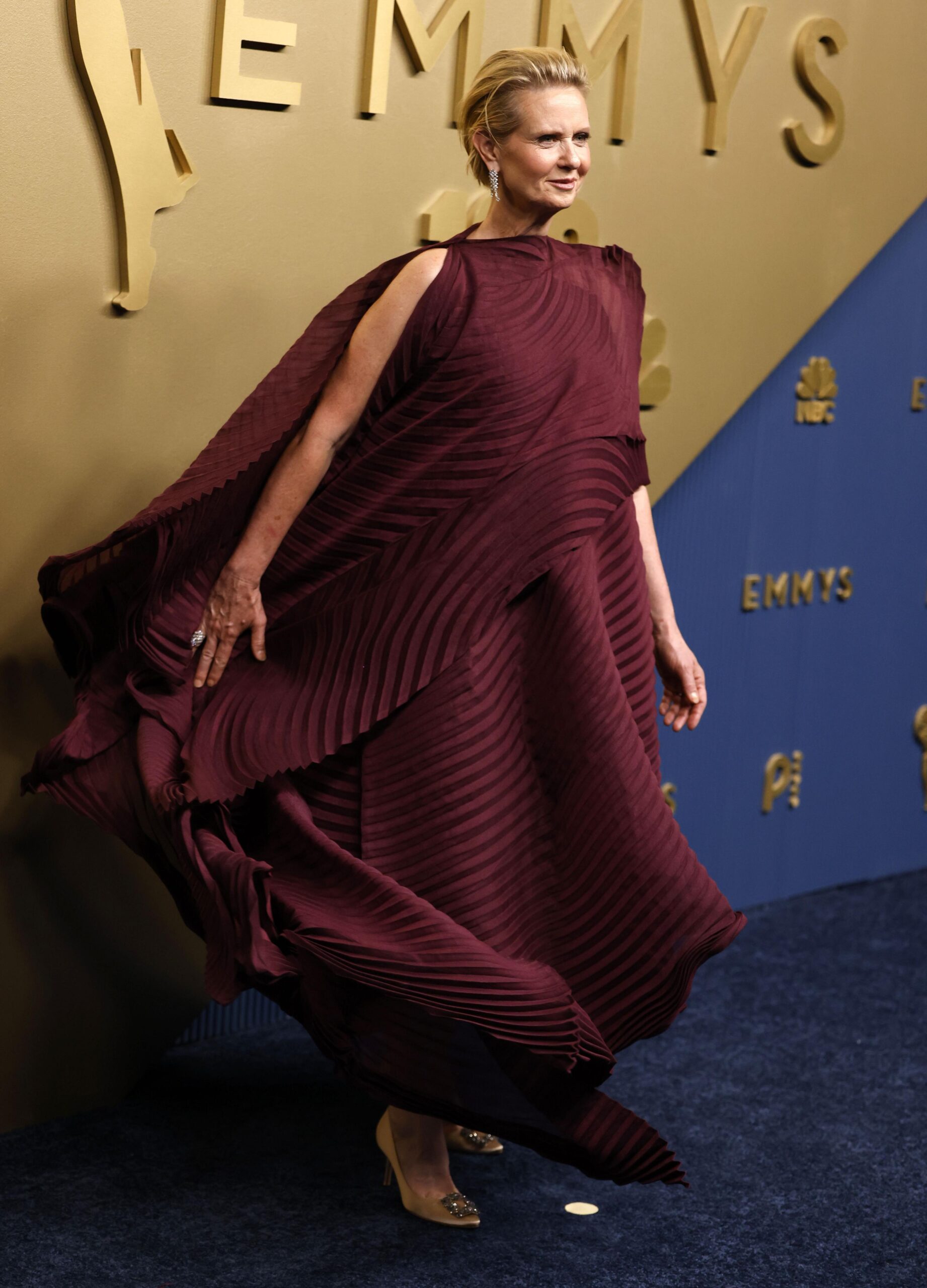 Cynthia Nixon in a patterned burgundy dress