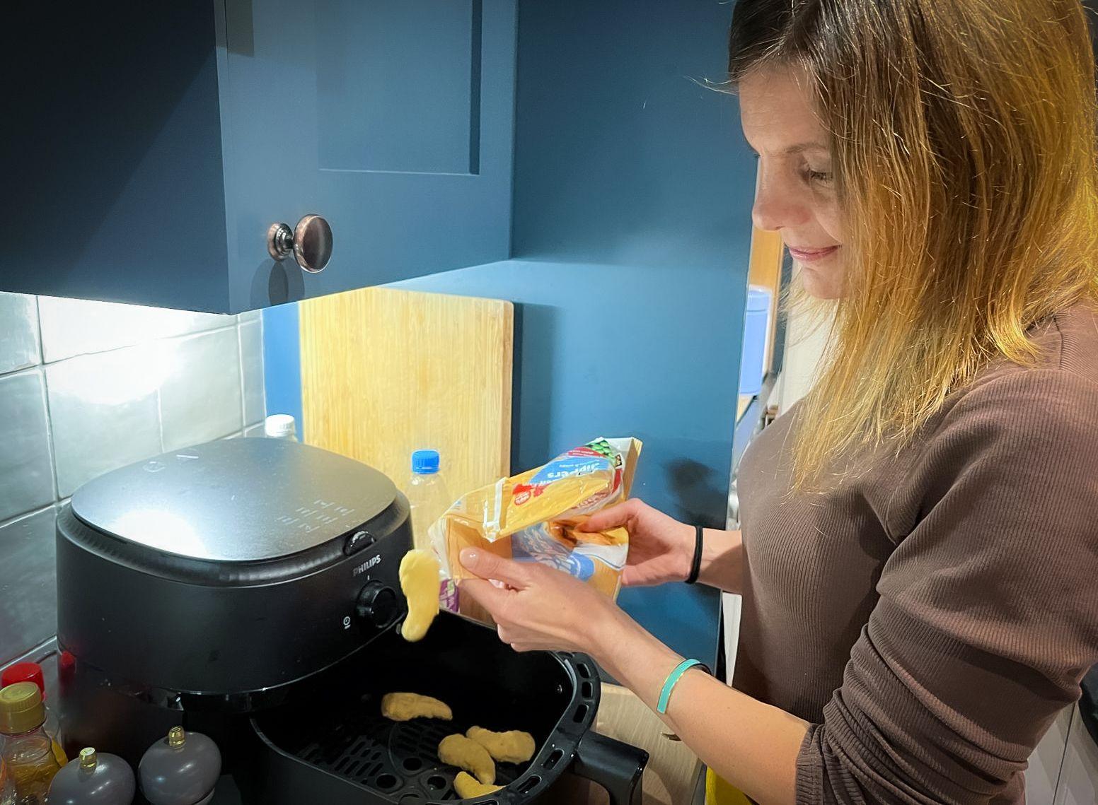 Ruth Clegg putting chicken nuggets into an air fryer