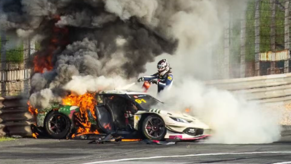 ‘I’m only alive thanks to one man’ – British driver rescued from car fire in China race Loek Hartog uses a fire extinguisher on Ollie Millroy's car before pulling him free at the China GT race in Shanghai