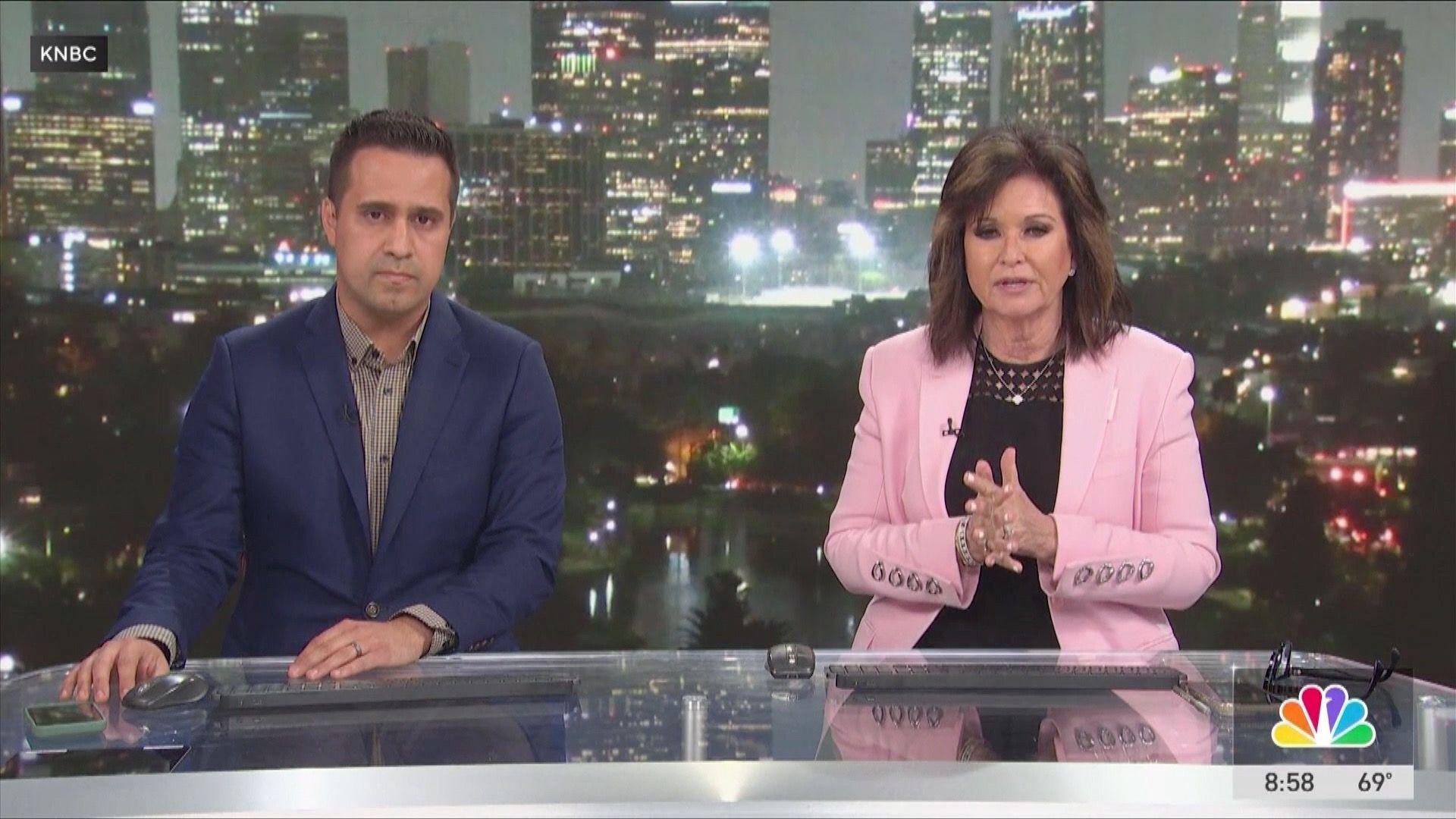 Man in navy suit and woman in pink blazer presenting news programme