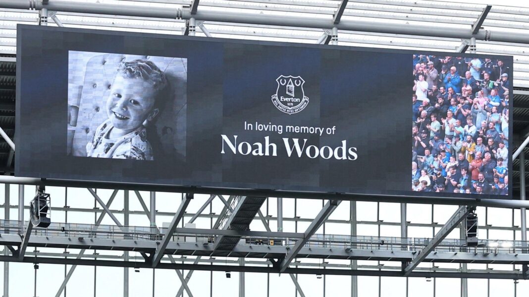 A big screen shows a picture of a smiling three-year-old boy, alongside the text: 