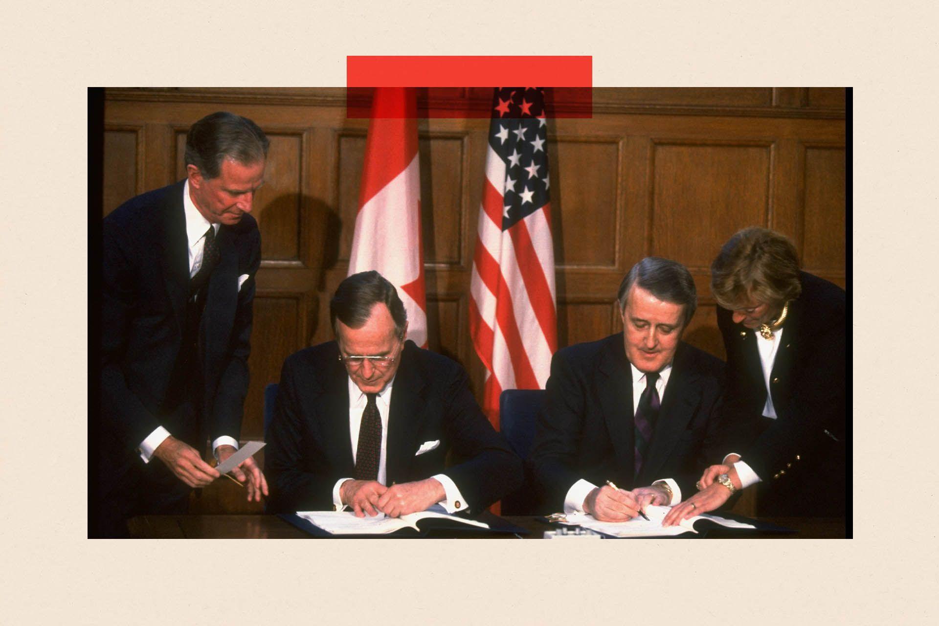 Pres. Mulroney (R) & Pres. Bush sitting, framed by flags, penning acid rain agreement in signing ceremony in Ottawa, Canada