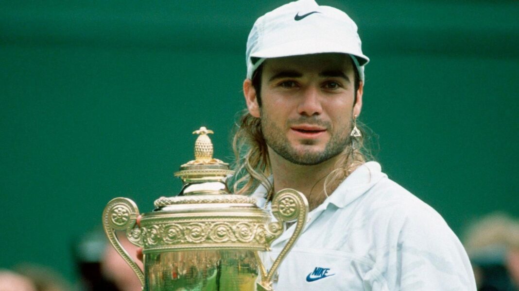 Andre Agassi celebrates with the trophy after winning Wimbledon in 1992