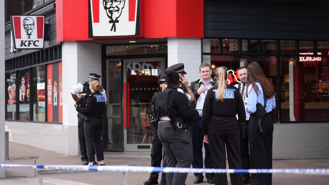 Four hurt and seven arrested in London stabbing Police stand nearby to the KFC