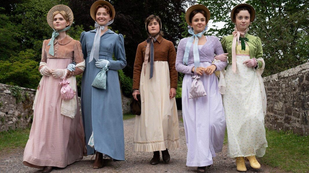 The Other Bennet Sister wraps filming Christmas special The two bennet sisters on the left and right wear colourful period costumes of dresses and cropped cardigan ( L-R- pink, blue, purple, green). Mary, in the middle, wears a more basic white dress, a brown cropped cardigan and a beige head scarf.