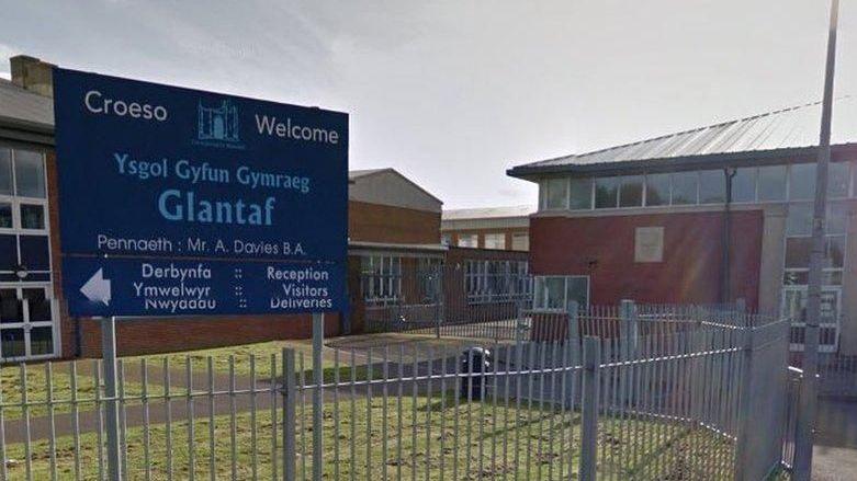Google image of the entrance to Ysgol Gyfun Gymraeg Glantaf in Cardiff, showing fencing, road and school buildings, as well as the entrance sign