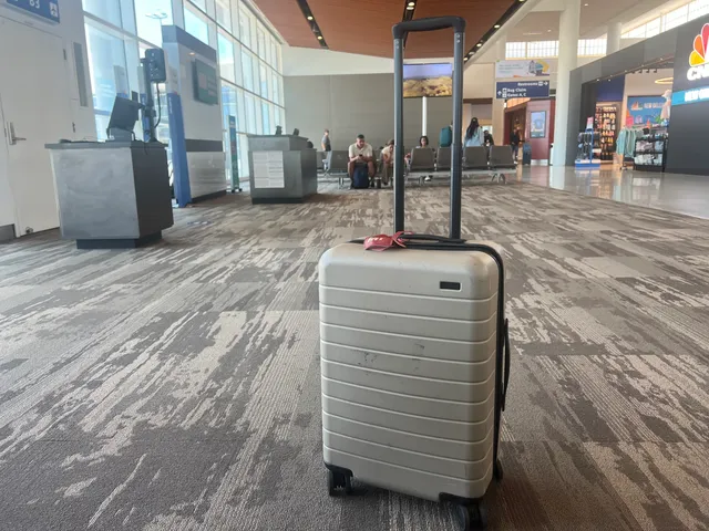 Image may contain: Baggage, Person, Chair, Furniture, Suitcase, Computer Hardware, Electronics, Hardware, Monitor, and Screen