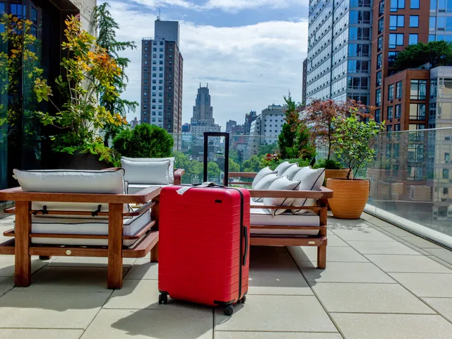 Image may contain: City, Baggage, Urban, Architecture, Building, Cityscape, and Suitcase
