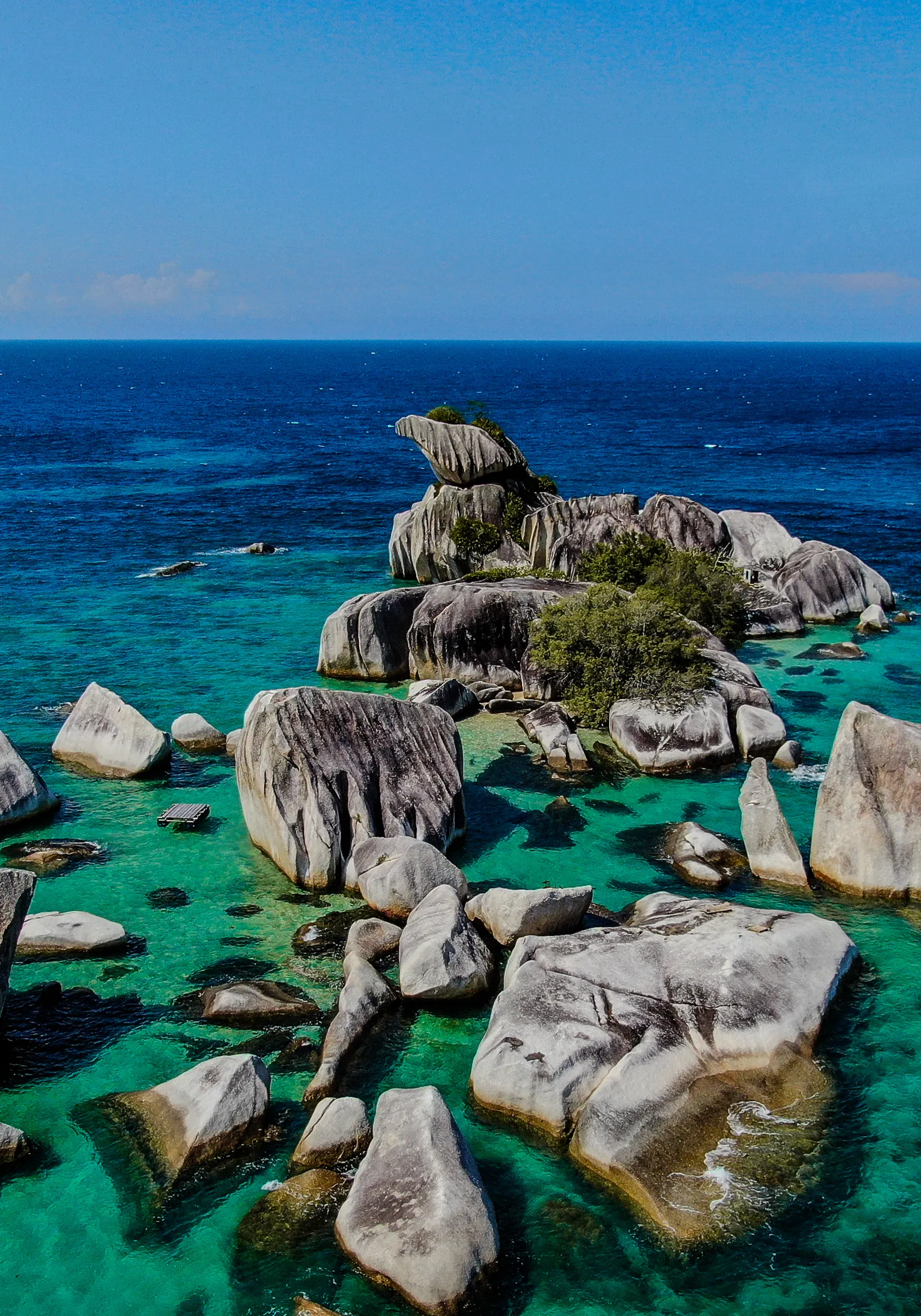 Image may contain Nature Outdoors Sky Sea Water Horizon Rock Coast Shoreline Scenery Lagoon Lake Land and Beach