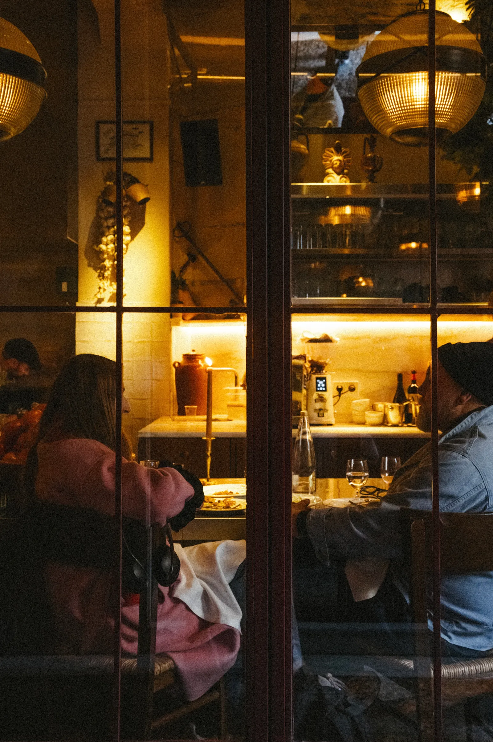 Image may contain Indoors Restaurant Lighting Photography Adult Person Door Urban Cafe Art and Painting